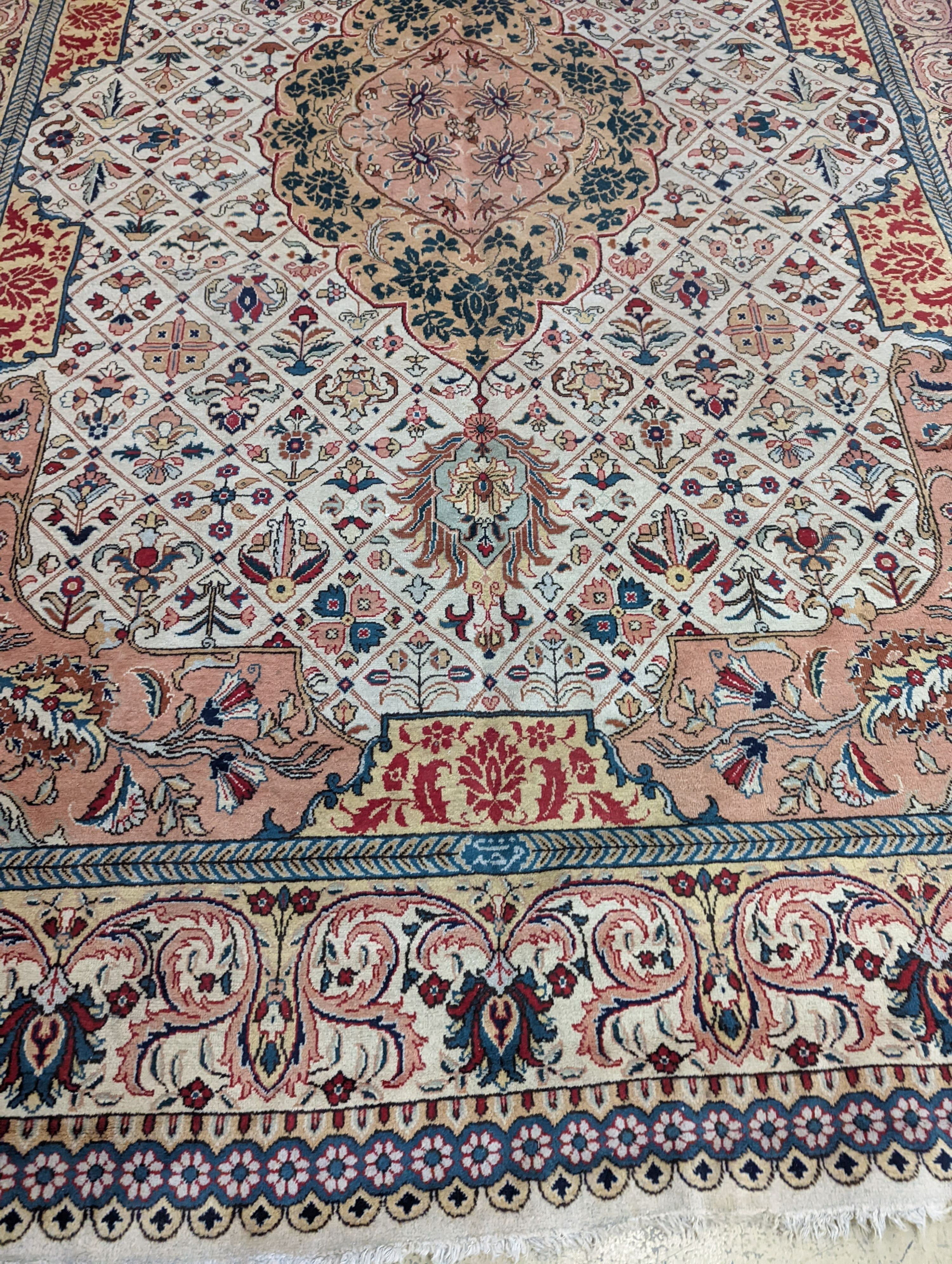 A Tabriz ivory ground carpet, 425 x 306cm